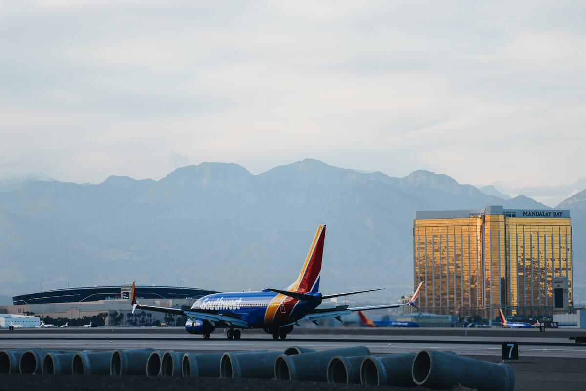 An airplane lands at Harry Reid International Airport on Wednesday, Dec. 20, 2023, in Las Vegas ...