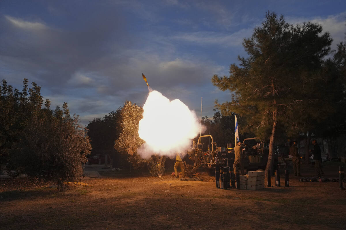 Israeli soldiers fire mortars from southern Israel towards the Gaza Strip, in a position near t ...