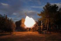 Israeli soldiers fire mortars from southern Israel towards the Gaza Strip, in a position near t ...