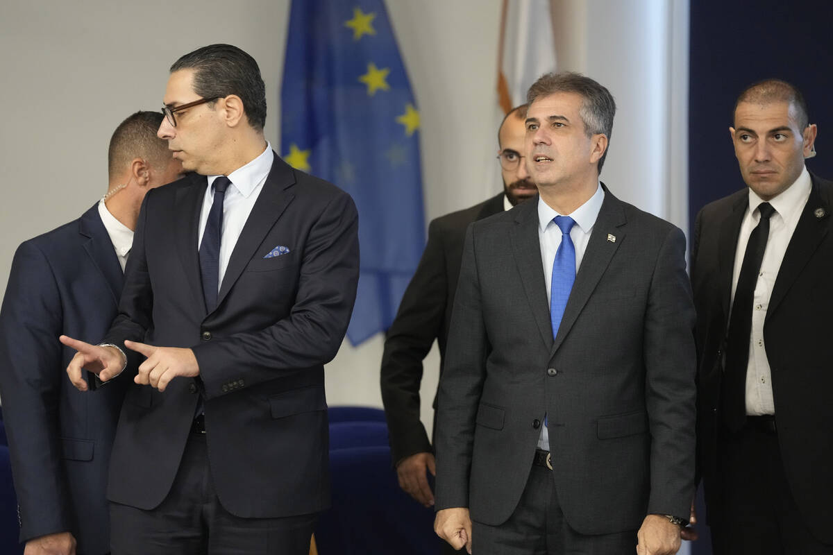 Israeli Foreign Minister Eli Cohen, right, and his Cypriot counterpart, Constantinos Kombos, le ...