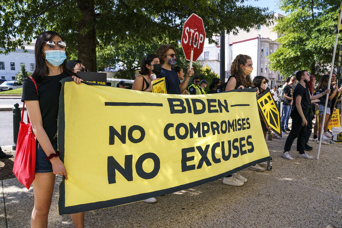 Climate change activists demonstrate outside the Hart Senate Office Building on Capitol Hill in ...