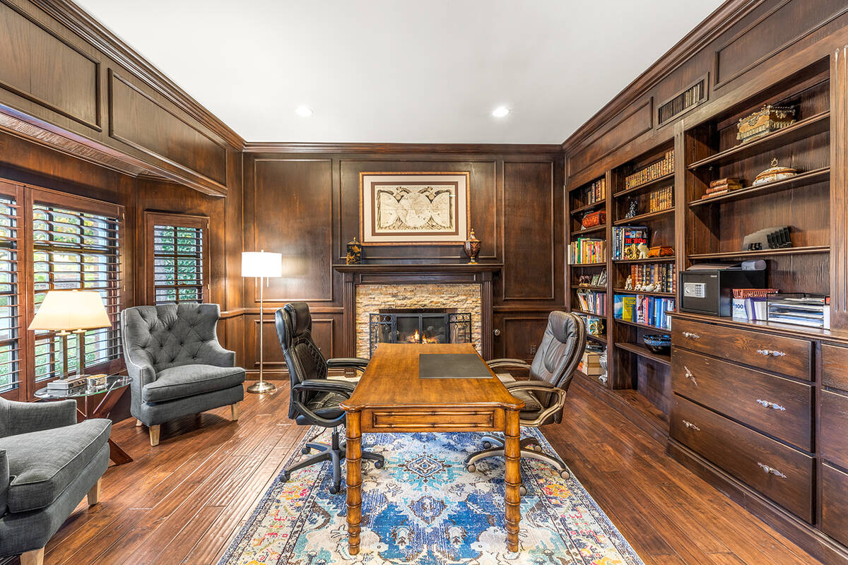 Authentic wood flooring leads guests to the office area with custom floor-to-ceiling wood finis ...