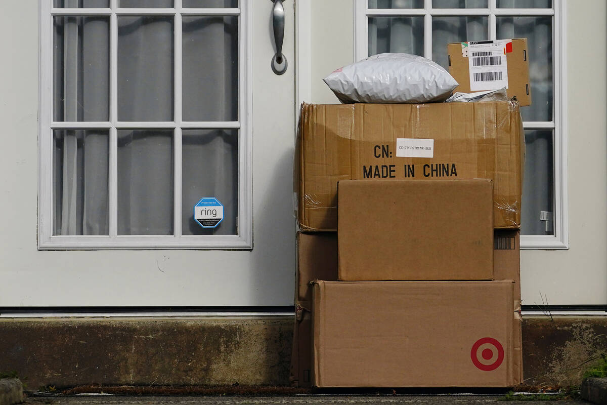 Packages are stacked on the doorstep of a home on Oct. 27, 2021, in Upper Darby, Pa. Retailers ...