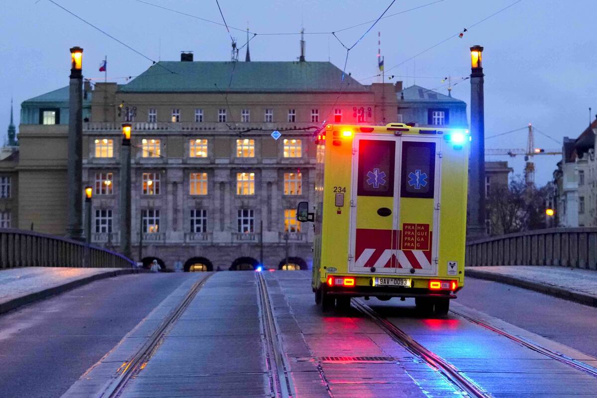 An ambulance drives towards the building of Philosophical Faculty of Charles University in down ...