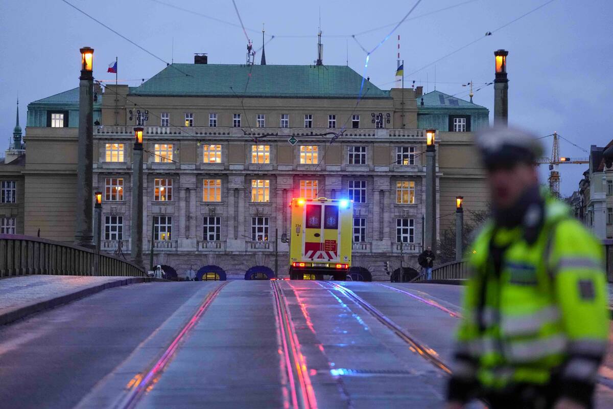 An ambulance drives towards the building of Philosophical Faculty of Charles University in down ...