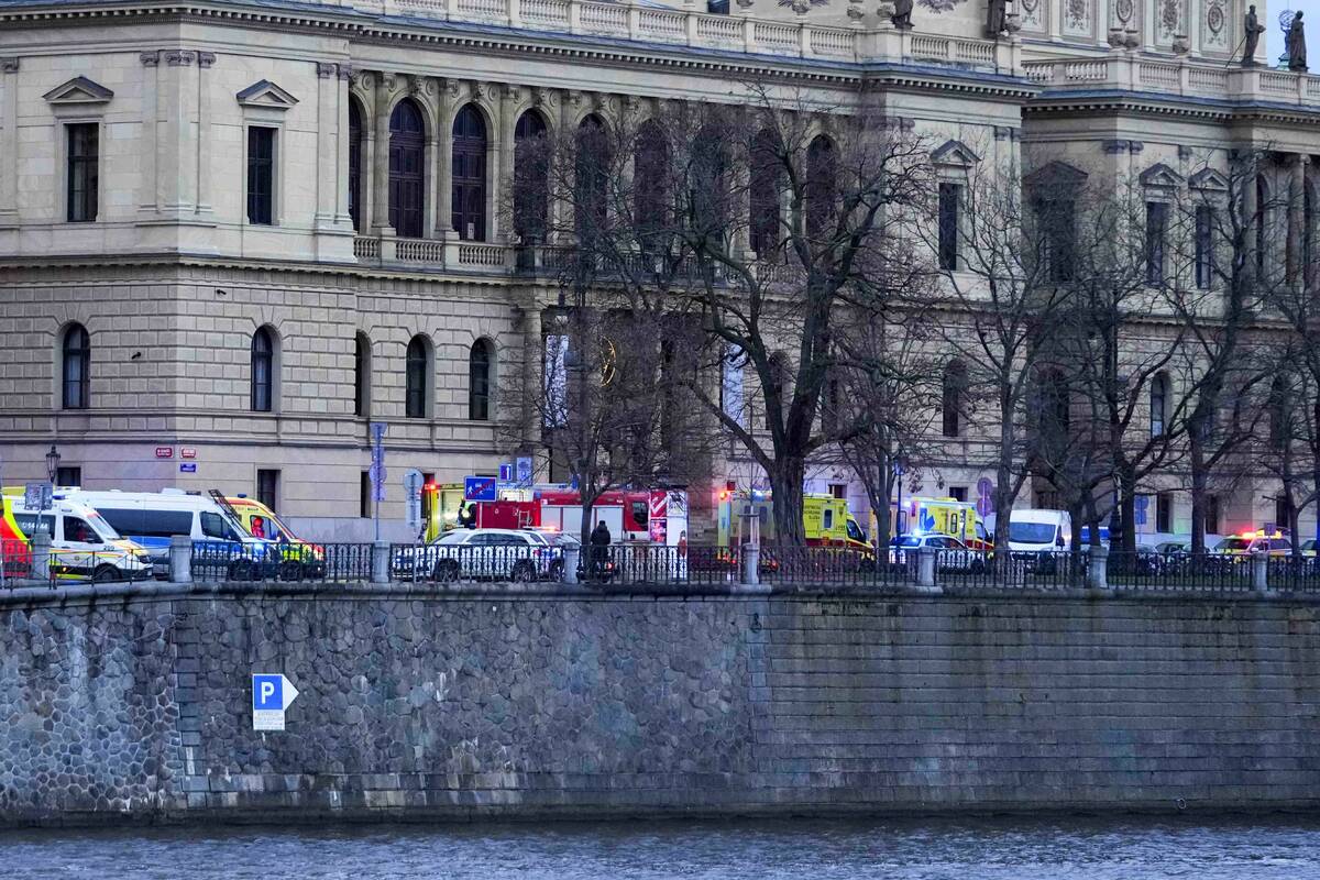 Police officers secure an area after a shooting in downtown Prague, Czech Republic, Thursday, D ...