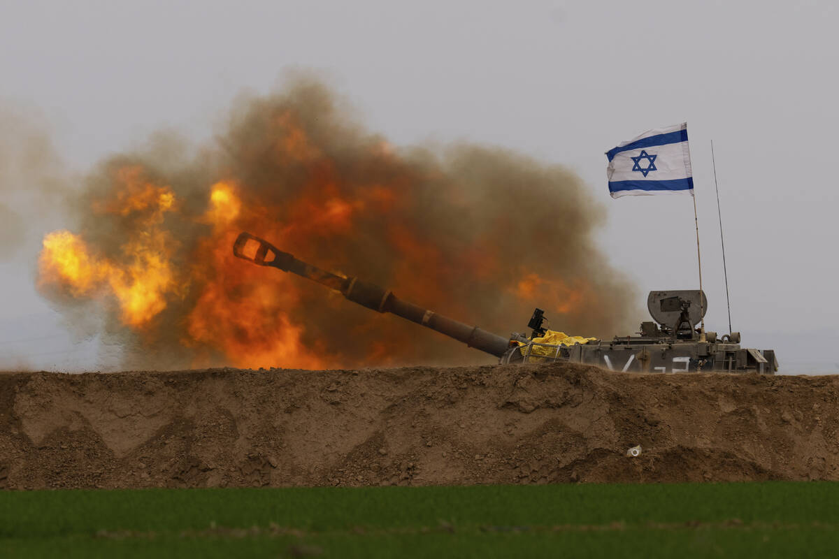 An Israeli mobile artillery unit fires a shell from southern Israel towards the Gaza Strip, in ...