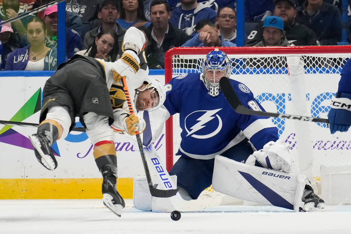 Vegas Golden Knights left wing William Carrier (28) gets tripped as he shoots on Tampa Bay Ligh ...