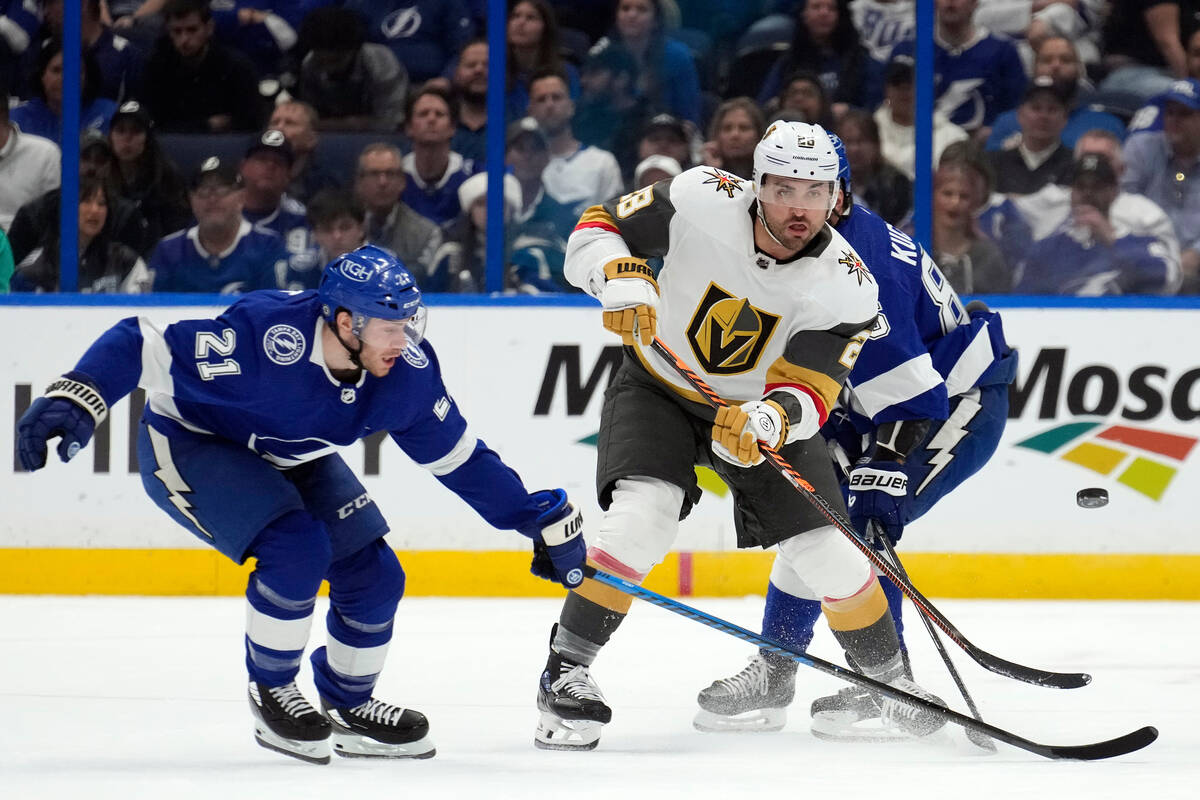 Vegas Golden Knights left wing William Carrier (28) flips the puck away from Tampa Bay Lightnin ...