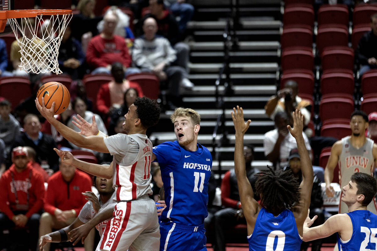 UNLV Rebels guard Dedan Thomas Jr. (11) shoots against Hofstra Pride forward Jacco Fritz (11) d ...