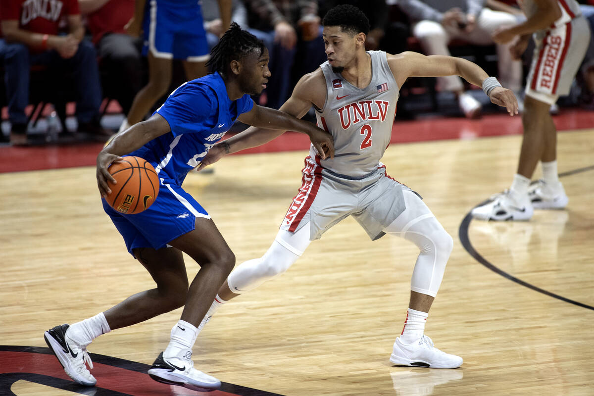 UNLV Rebels guard Justin Webster (2) defends against Hofstra Pride guard Tyler Thomas (23) duri ...