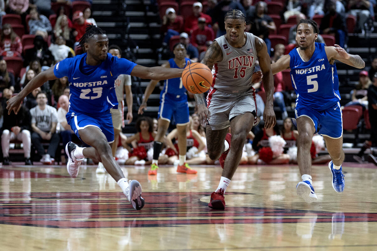 Hofstra Pride guard Tyler Thomas (23), UNLV Rebels guard Luis Rodriguez (15) and Pride guard Ja ...