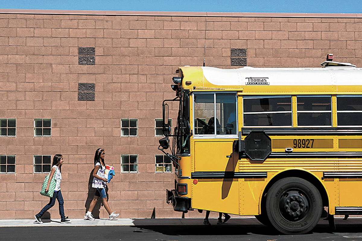 RJ FILE*** JOHN LOCHER/LAS VEGAS REVIEW-JOURNAL A school bus idles in the parking lot of the Ma ...