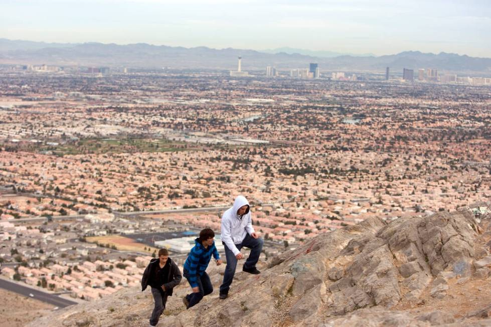Carson Lada, 14, Joshua Gibson, 15, and John Rivas, 14, climb Lone Mountain in Northwest Las Ve ...