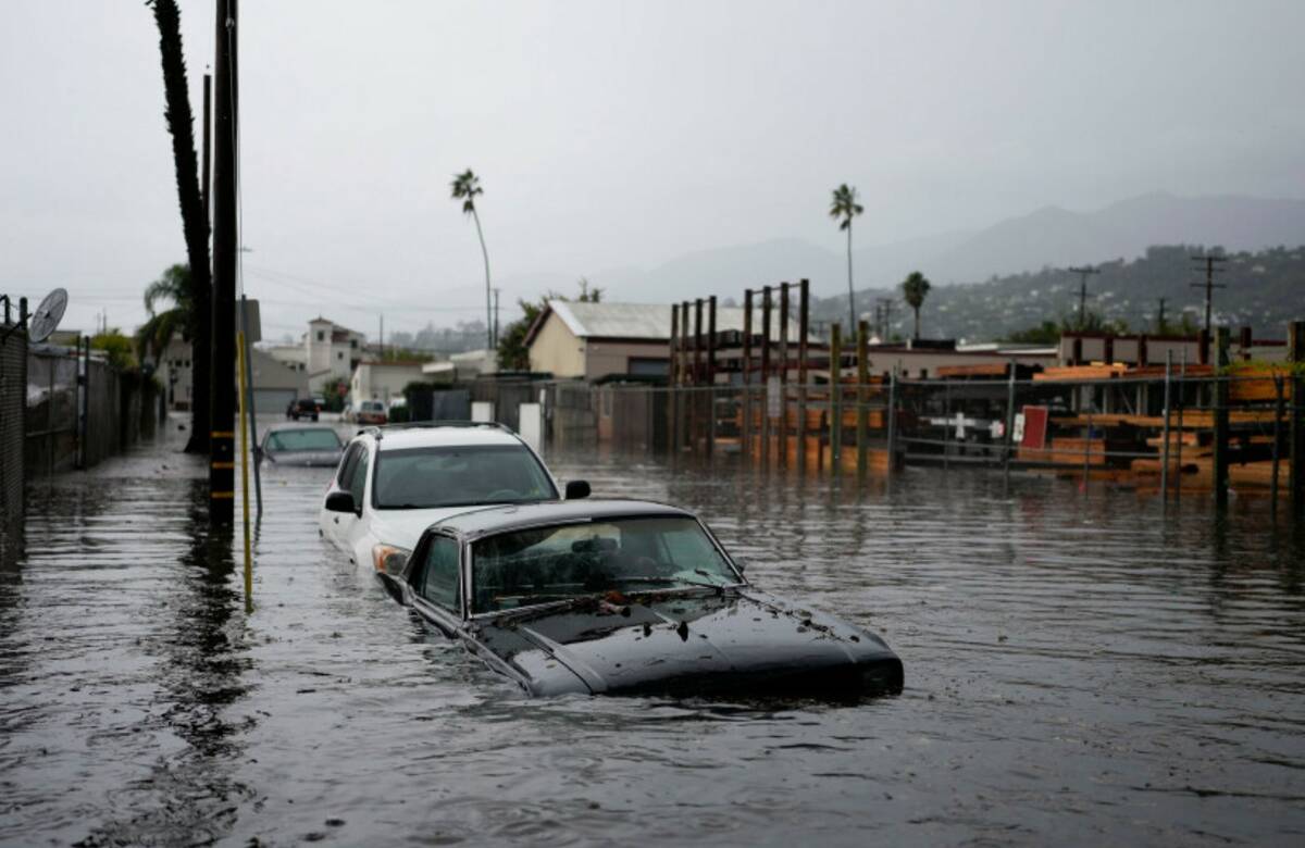 Cars are submerged on a flooded street during a rain storm, Thursday, Dec. 21, 2023, in Santa B ...