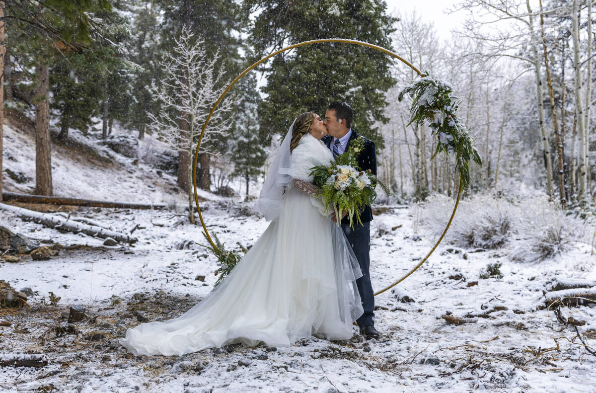 Bride Mckenzie Jane Stratton of Washington kisses groom Joao Paulo Taborda da Silva of Brazil a ...