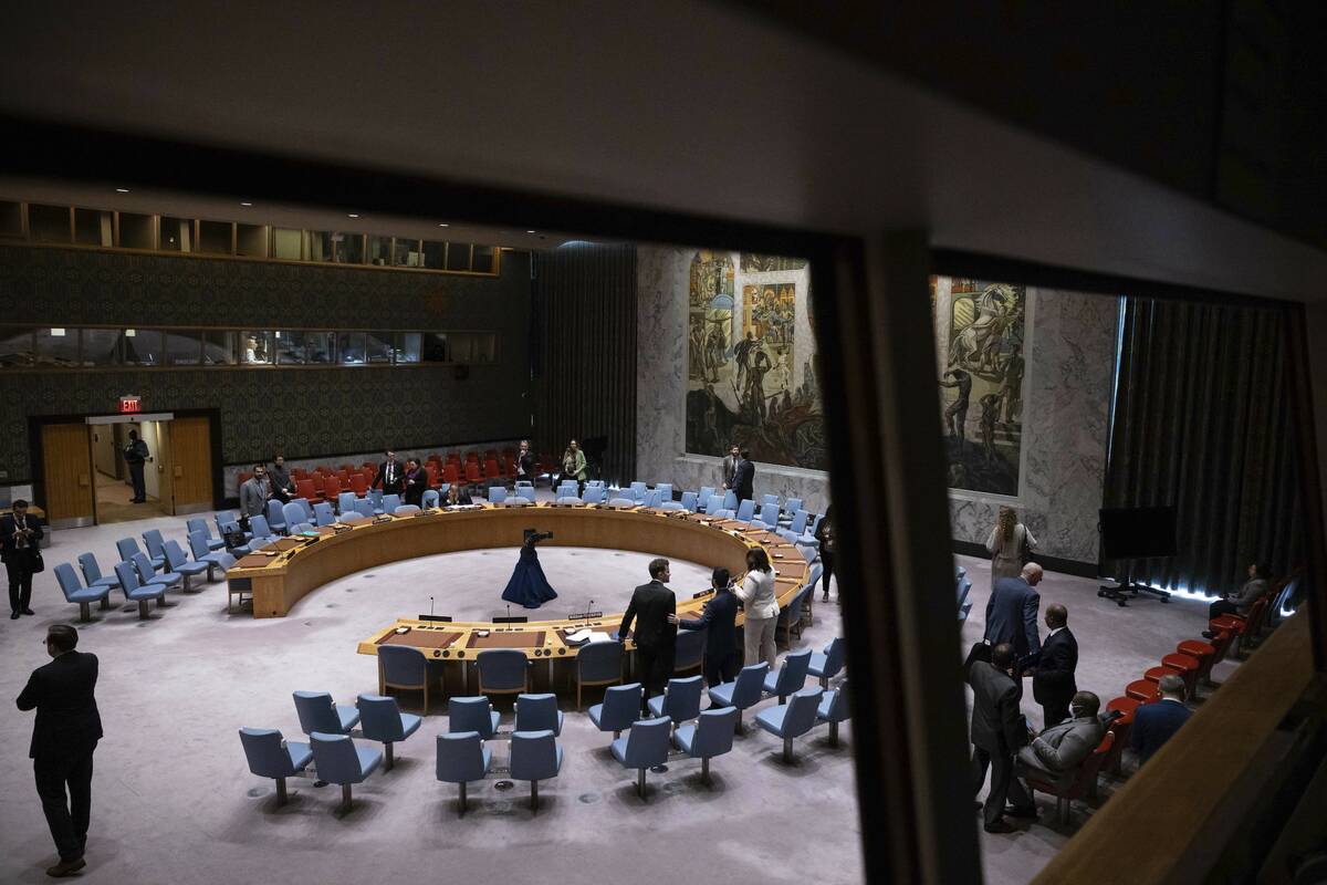 People gather during the Security Council meeting at United Nations headquarters, Friday, Dec. ...