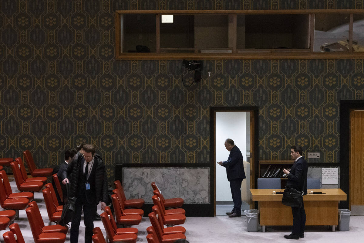 People stand in Security Council chamber at United Nations headquarters, Friday, Dec. 22, 2023. ...