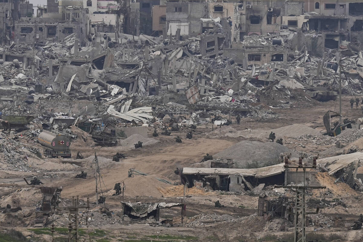 Israeli troops take positions in the Gaza Strip as seen from southern Israel, Thursday, Dec. 21 ...