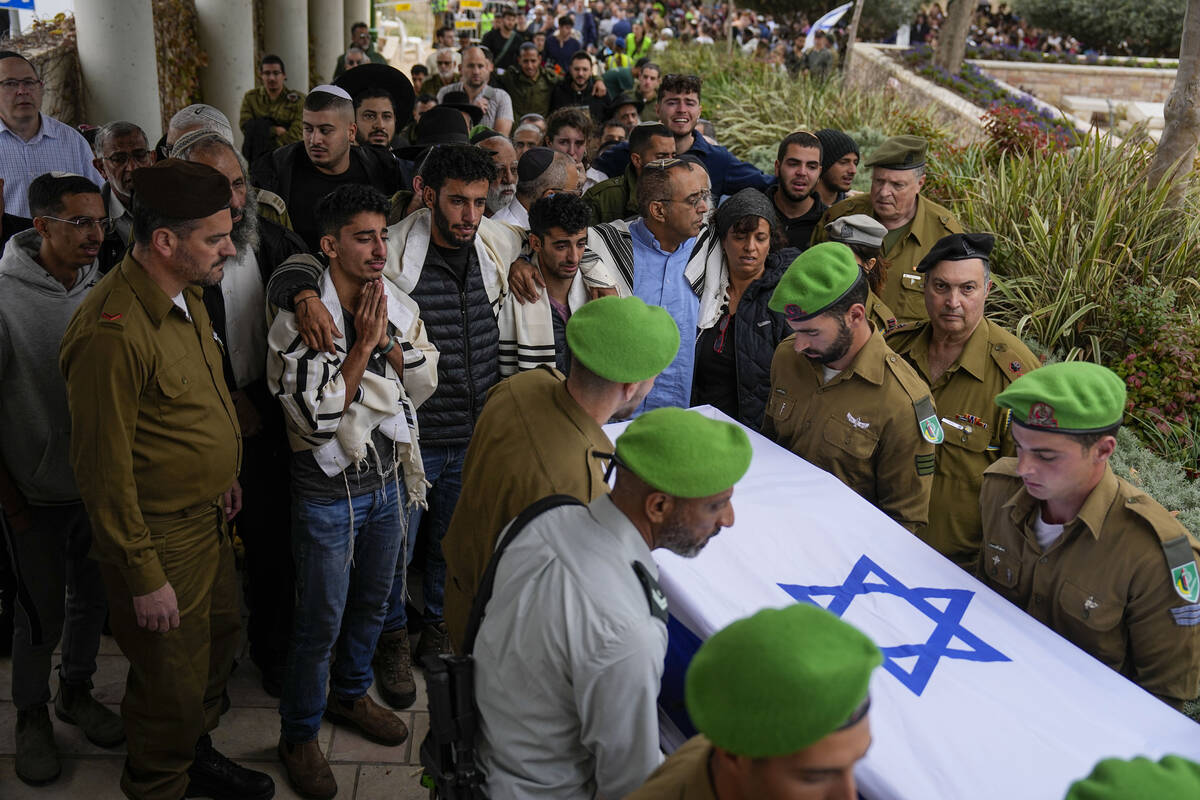 Israeli soldiers carry the flagged covered coffin of Sergeant Lavi Ghasi as family and friends ...