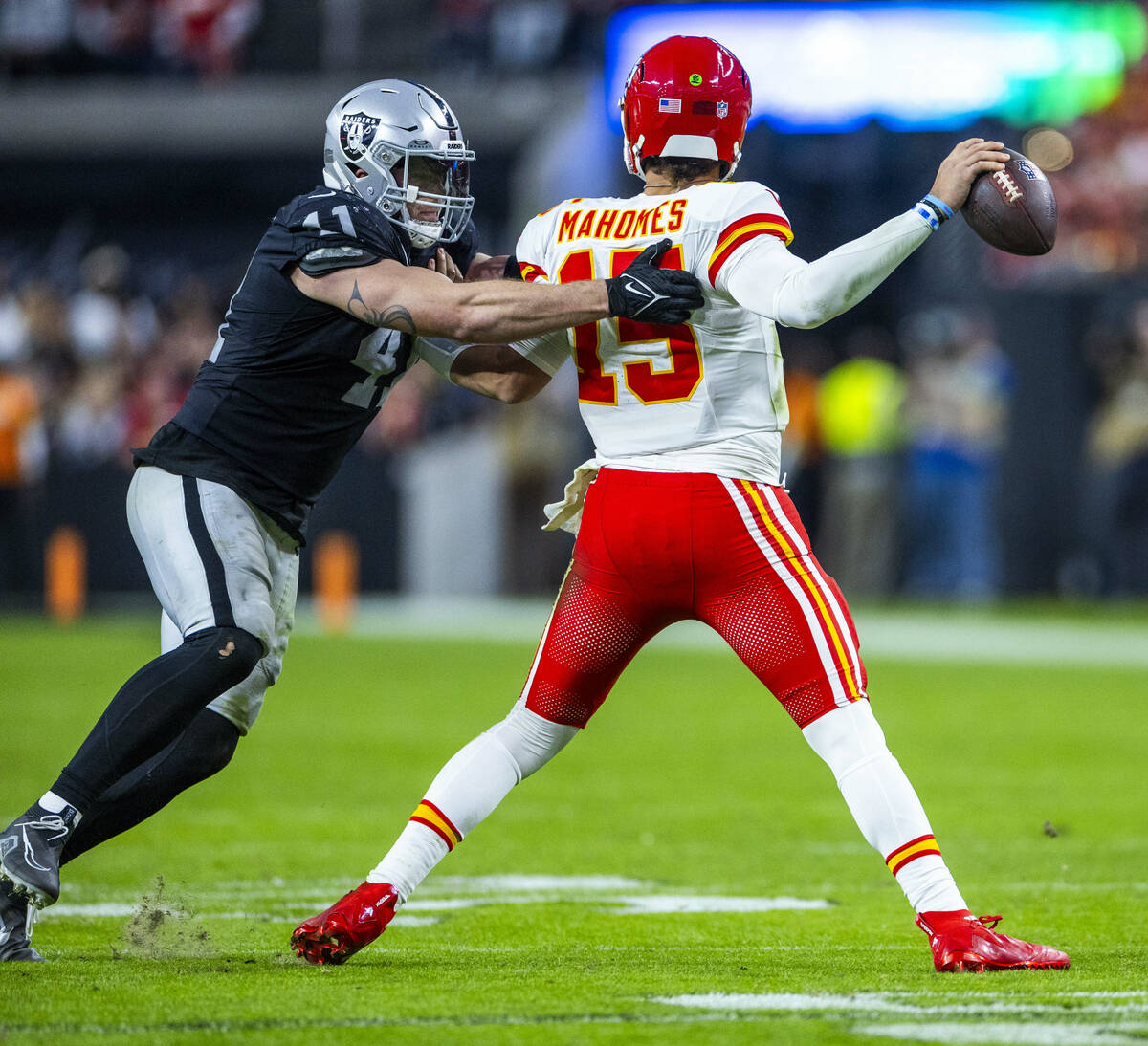 Raiders linebacker Robert Spillane (41) grabs Kansas City Chiefs quarterback Patrick Mahomes (1 ...