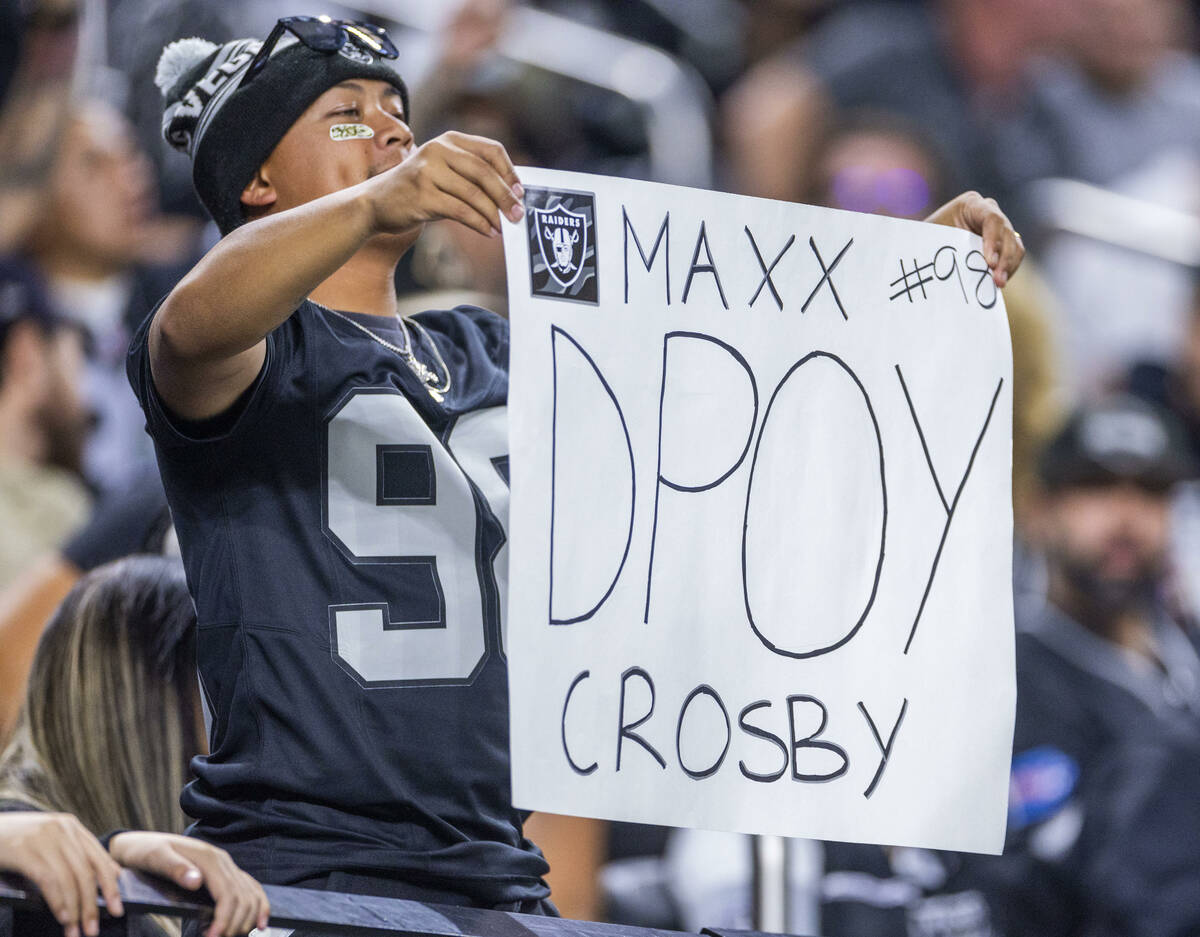 A Raiders fan holds a sign for defensive end Maxx Crosby (98) against the New York Jets during ...
