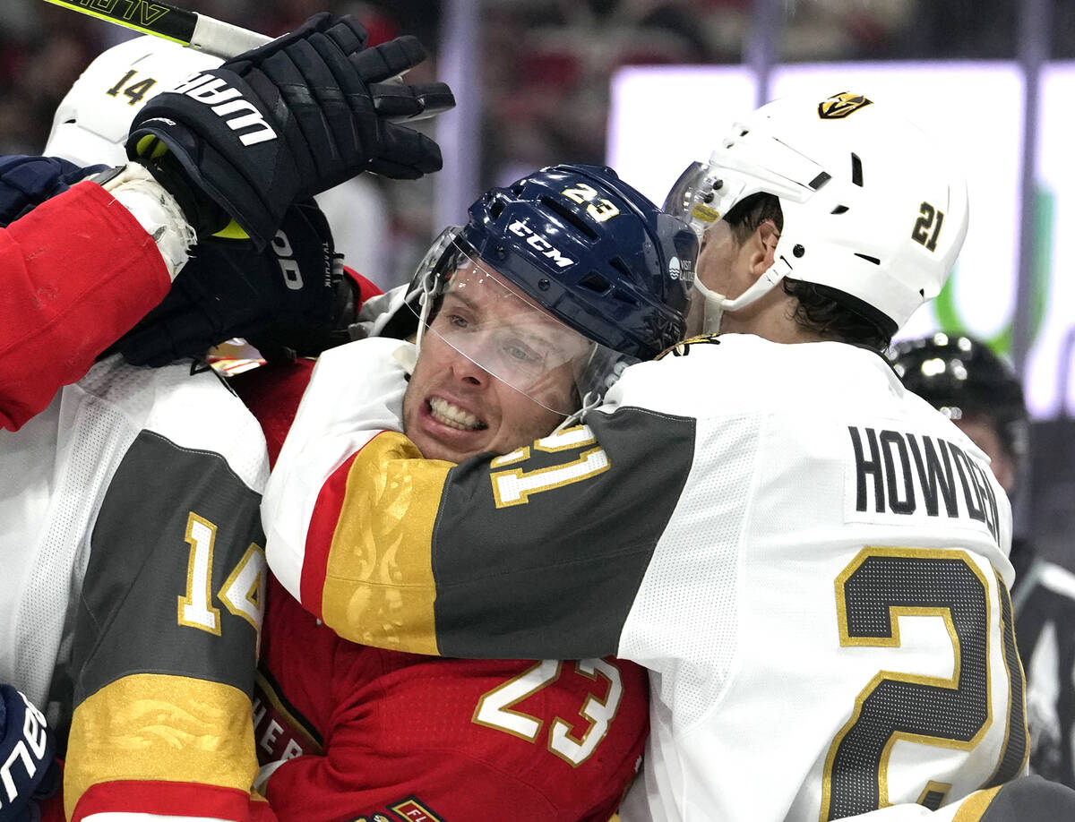 Florida Panthers center Carter Verhaeghe (23) is caught by Vegas Golden Knights center Brett Ho ...