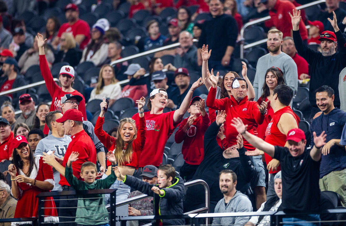 Utah Utes fans reach for A free t-shirt as they battle the Northwestern Wildcats during the fir ...
