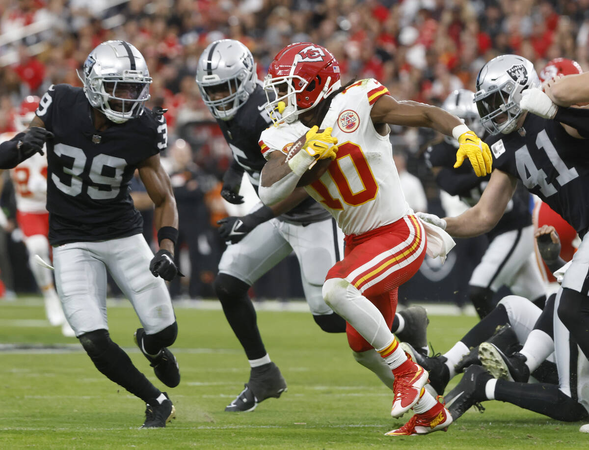 Kansas City Chiefs running back Isiah Pacheco (10) runs with the ball against Raiders defense d ...