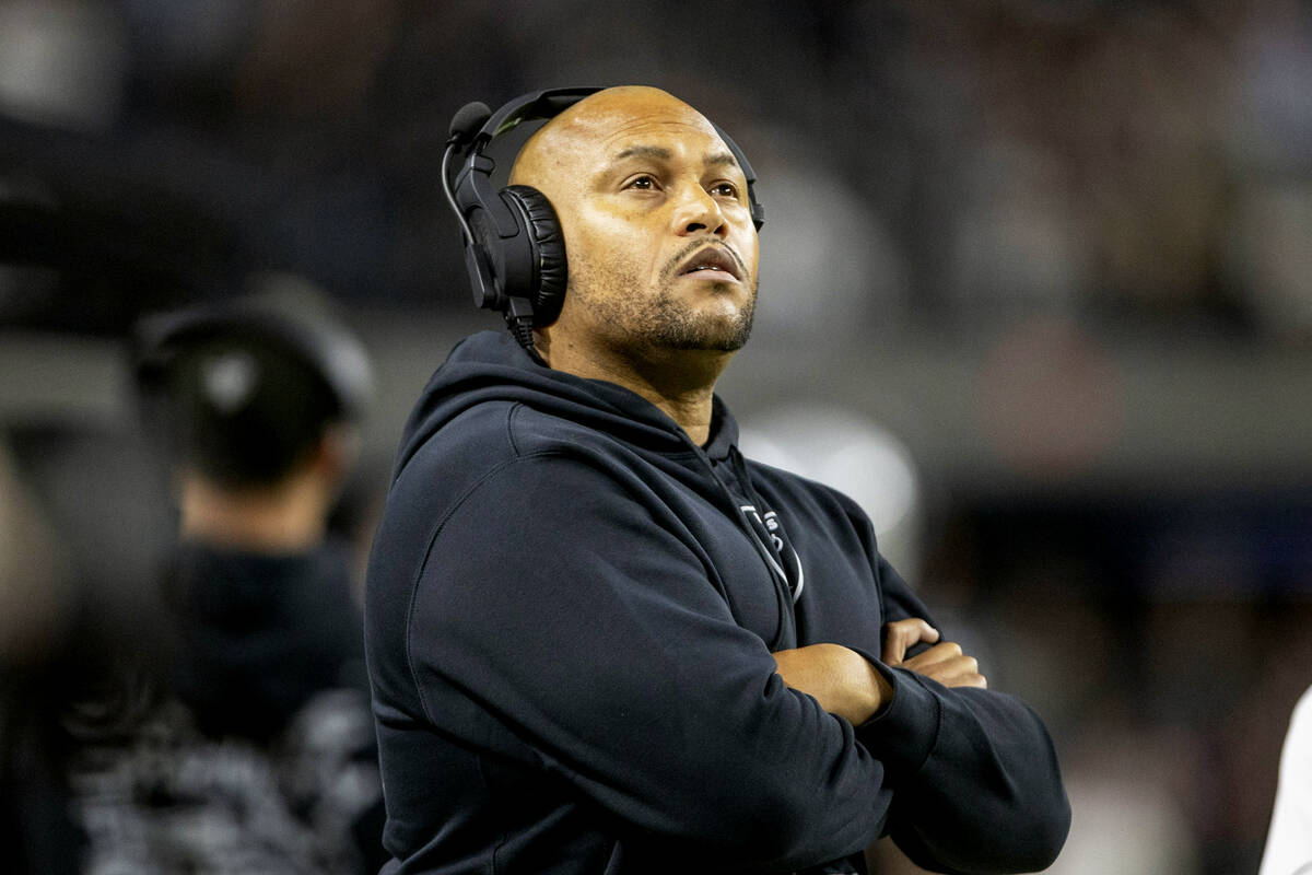 Raiders head coach Antonio Pierce looks to the replay monitor during the first half of an NFL g ...