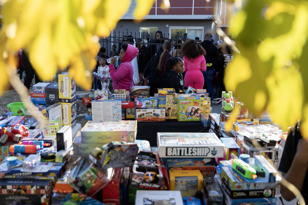 Free toys are available to neighborhood children during a Christmas block party organized by Ta ...