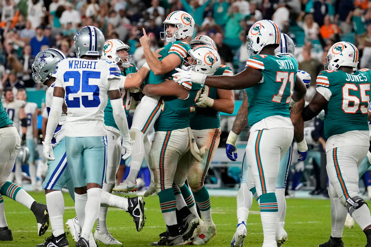 Miami Dolphins place kicker Jason Sanders, center, celebrates after kicking the game winning fi ...