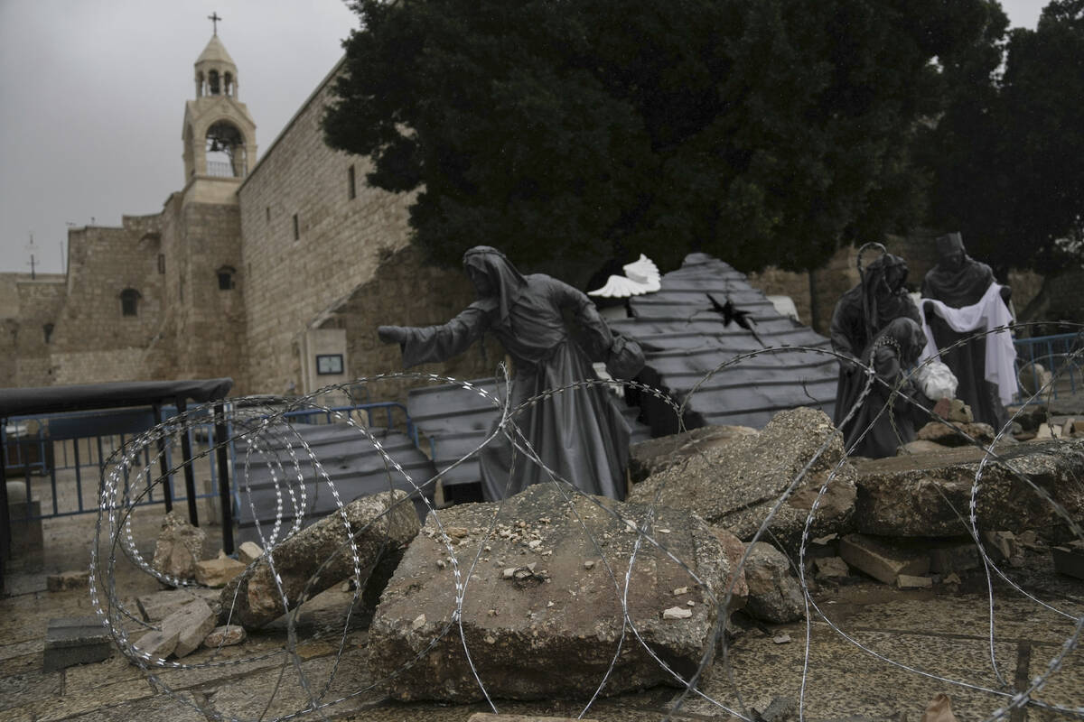 A nativity scene decorated to honor the victims in Gaza is displayed in Manger Square, near the ...