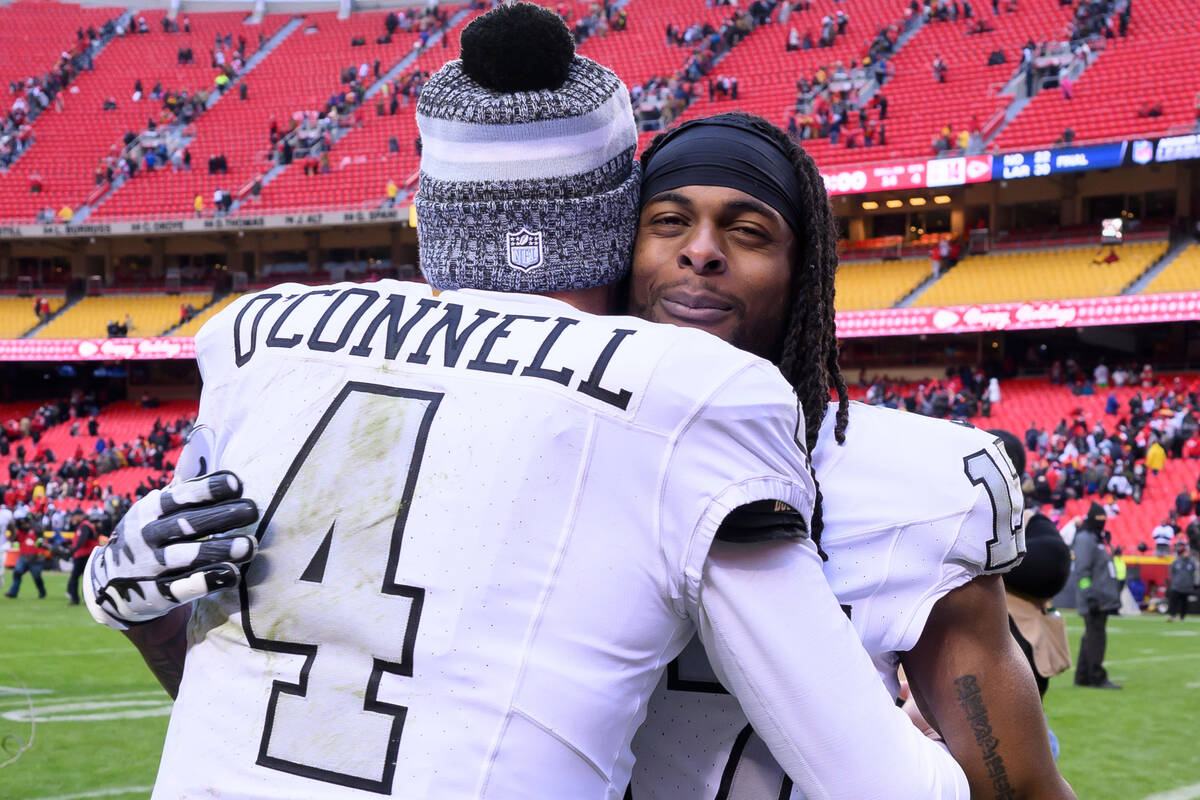 Las Vegas Raiders wide receiver Davante Adams, right, hugs Raiders quarterback Aidan O'Connell ...