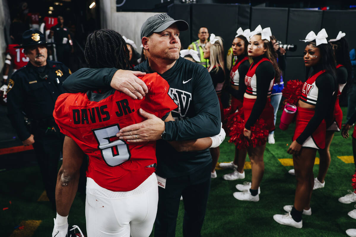 UNLV head coach Barry Odom hugs UNLV running back Vincent Davis Jr. after losing the Mountain W ...