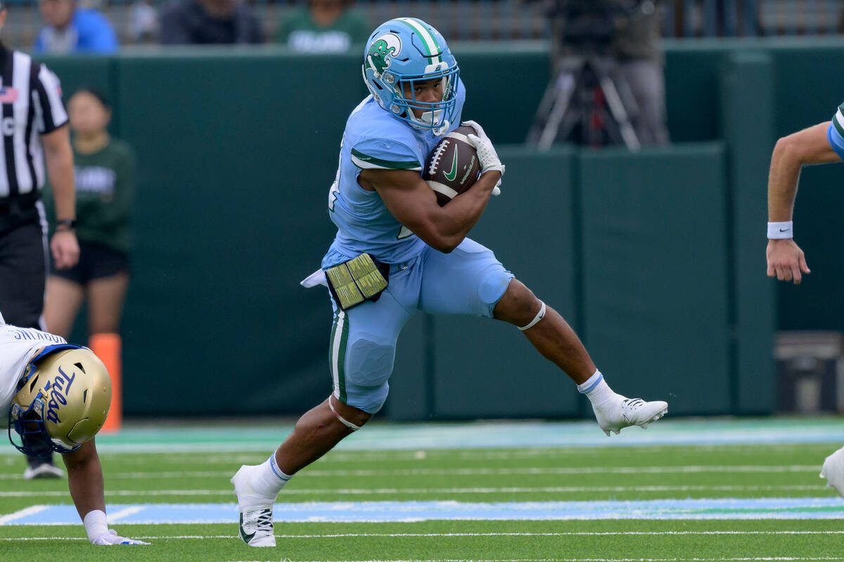 Tulane running back Makhi Hughes (21) runs during an NCAA college football game against Tulsa, ...