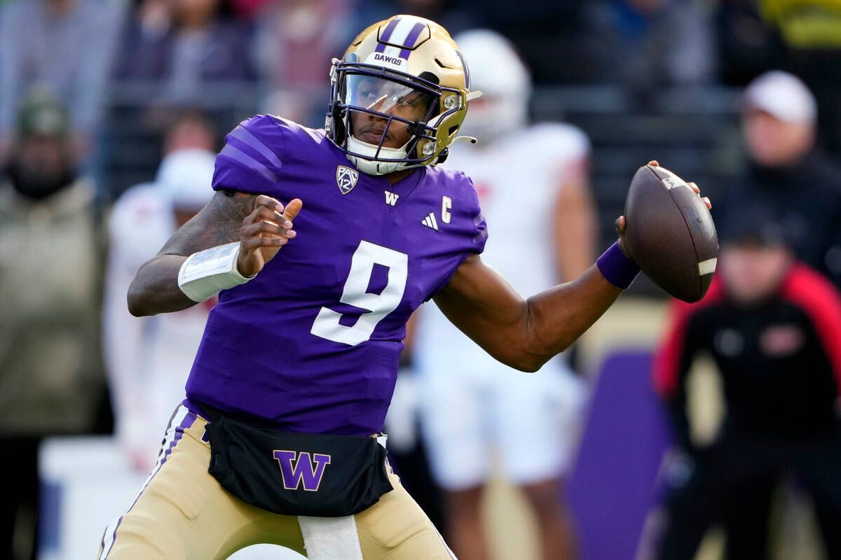 Washington quarterback Michael Penix Jr. looks to throw against Utah during the first half of a ...