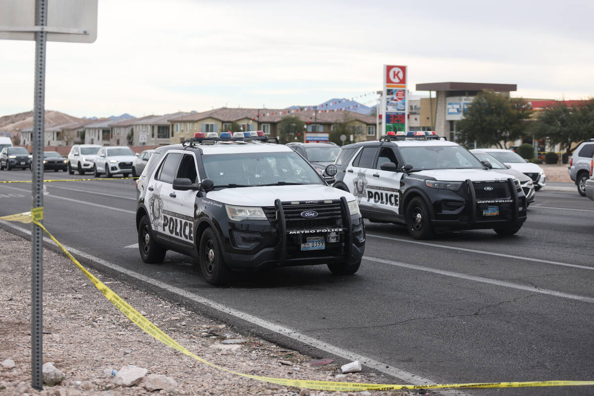 A police car with bullet holes at the scene of an officer involved shooting in the area of Blue ...