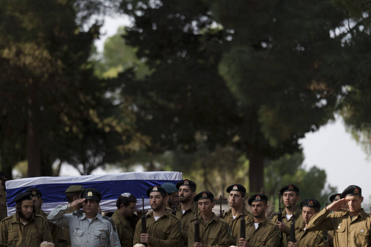 Israeli soldiers carry the coffin of the staff sergeant Elisha Yehonatan Lober, who was killed ...