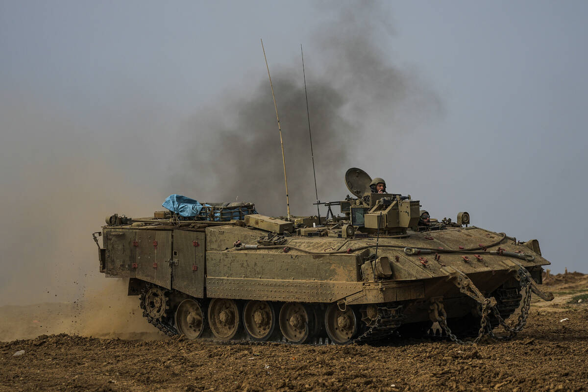 An Israeli armoured personnel carrier (APC) moves near the Gaza Strip border, in southern Israe ...