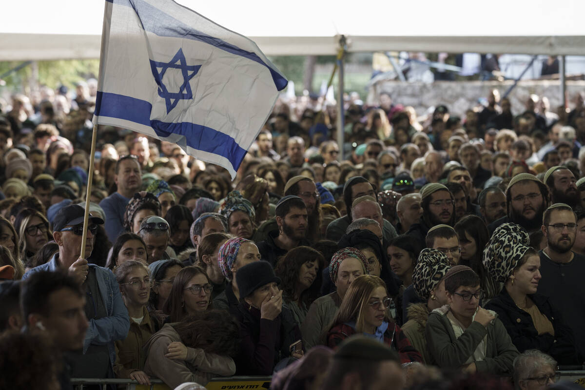 Mourners attend the funeral of Israeli staff sergeant Elisha Yehonatan Lober, who was killed in ...