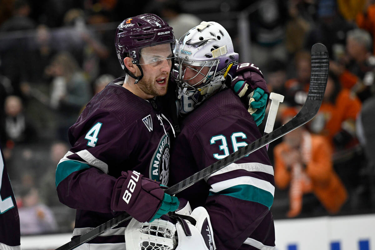 Anaheim Ducks defenseman Cam Fowler, left, celebrates with goaltender John Gibson after the Duc ...