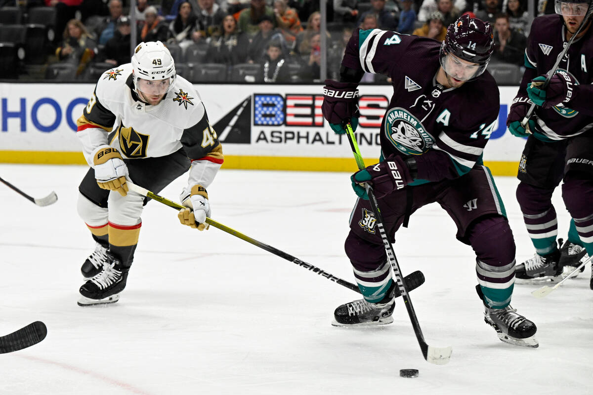 Anaheim Ducks center Adam Henrique (14) controls the puck with Vegas Golden Knights center Ivan ...