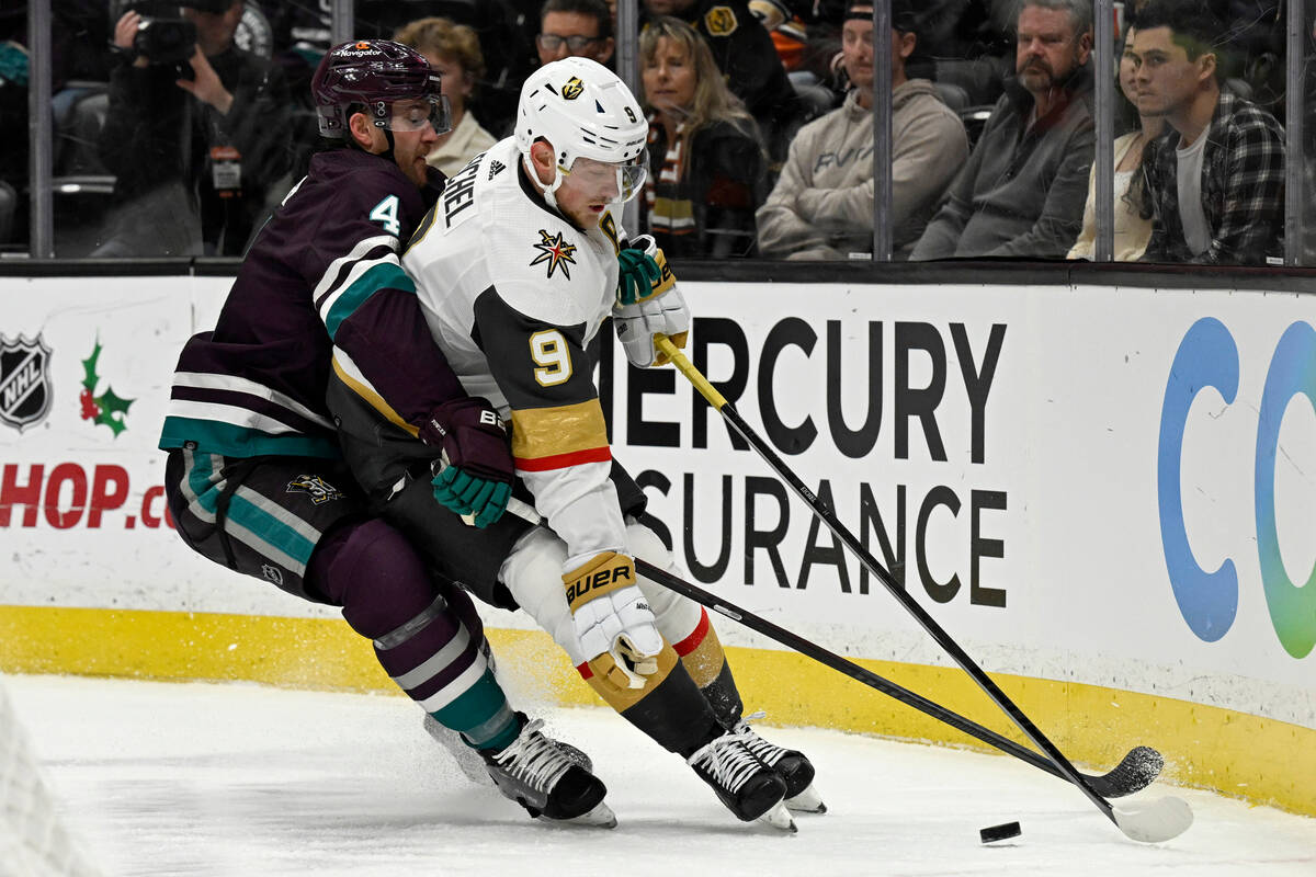 Vegas Golden Knights center Jack Eichel (9) controls the puck with pressure from Anaheim Ducks ...