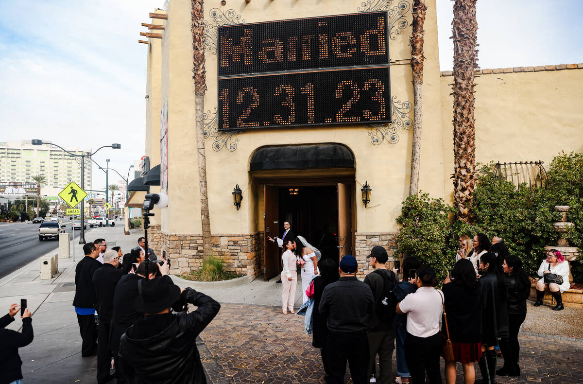 Anamarie Popoca, left, and Michelle Antonio, right, kiss after their wedding at the Viva Las Ve ...