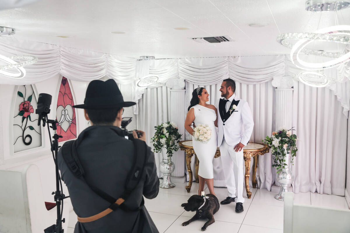 Samantha Castrejon, left, and Yvan Devergranne, right, pose for photos after their wedding at t ...