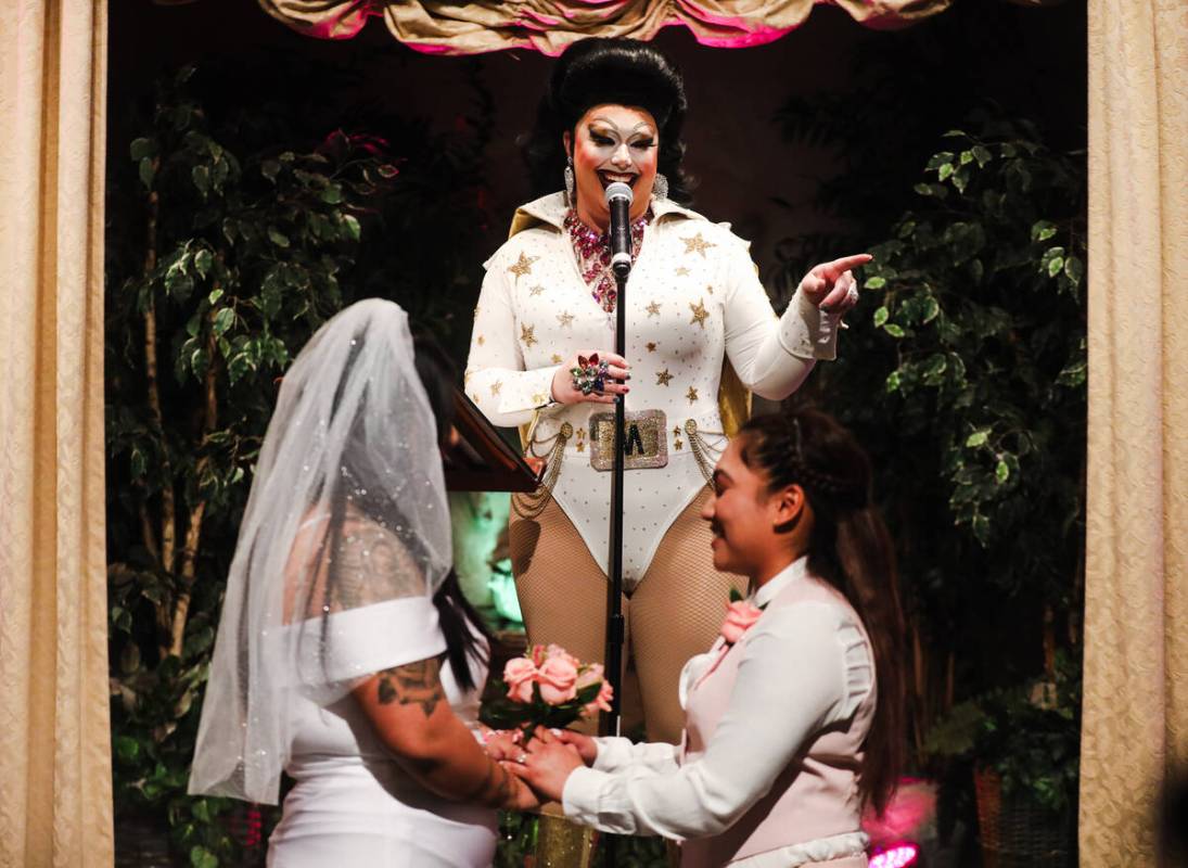 Martina “Sh-Elvis” Brookshire officiates the wedding of Michelle Antonio, left, a ...