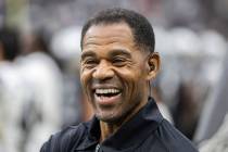 Former Raider player Eric Allen shares a laugh with staff on the sideline during a special trai ...