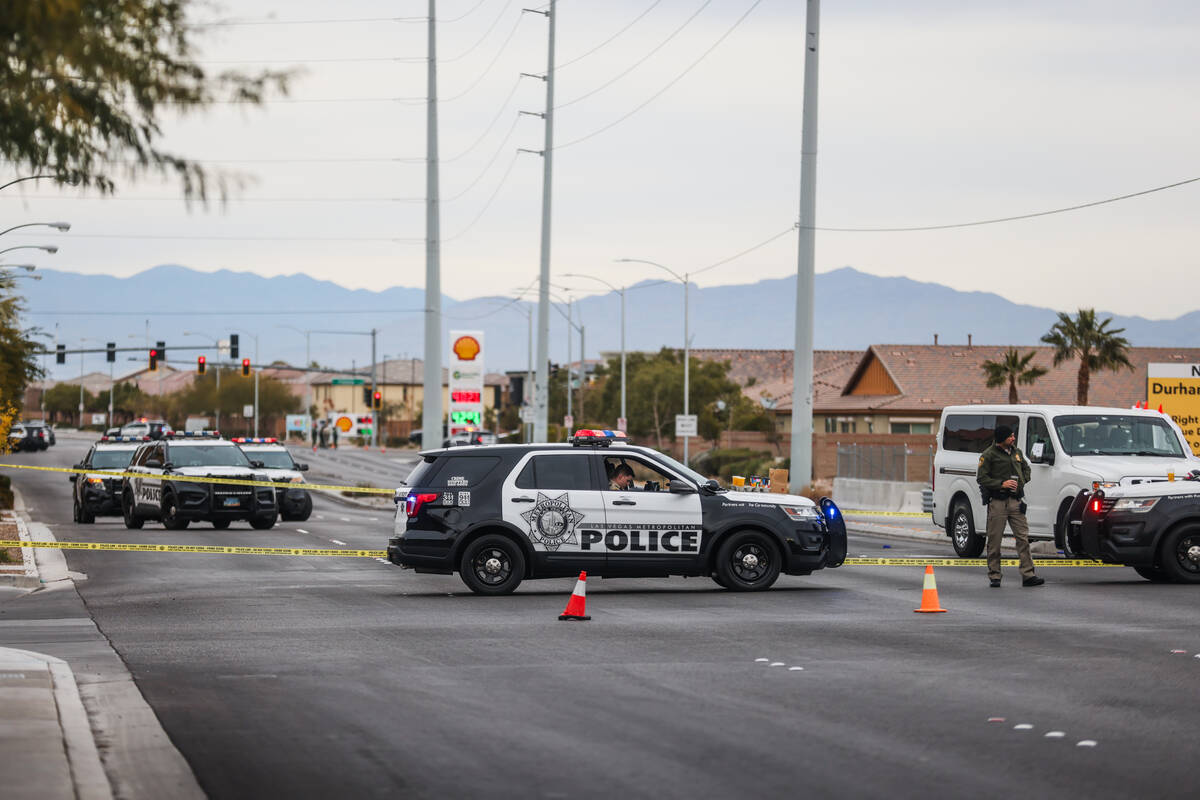 Police investigate the scene of an officer involved shooting in the area of Blue Diamond Road a ...