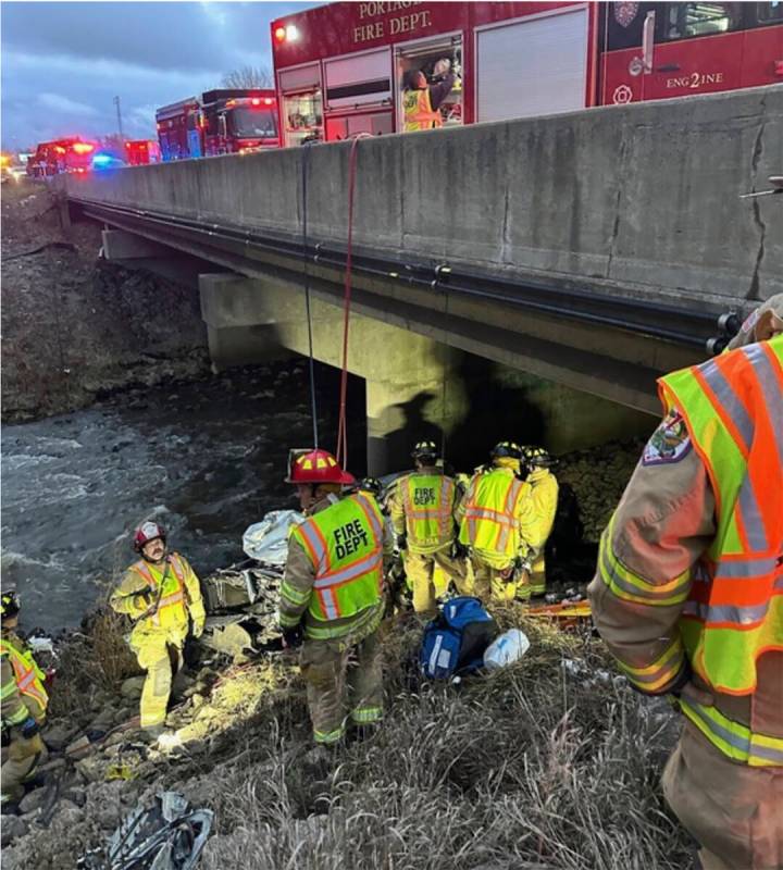 This photo provided by the Indiana State Police, police rescue a man after finding his damaged ...